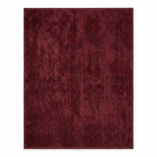 Plush solid burgundy hand-tufted wool rug showcasing a dense, luxurious cut pile texture on a clean white background.