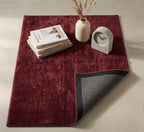 Plush solid burgundy hand-tufted wool rug showcasing a dense, luxurious cut pile texture on a clean white background.